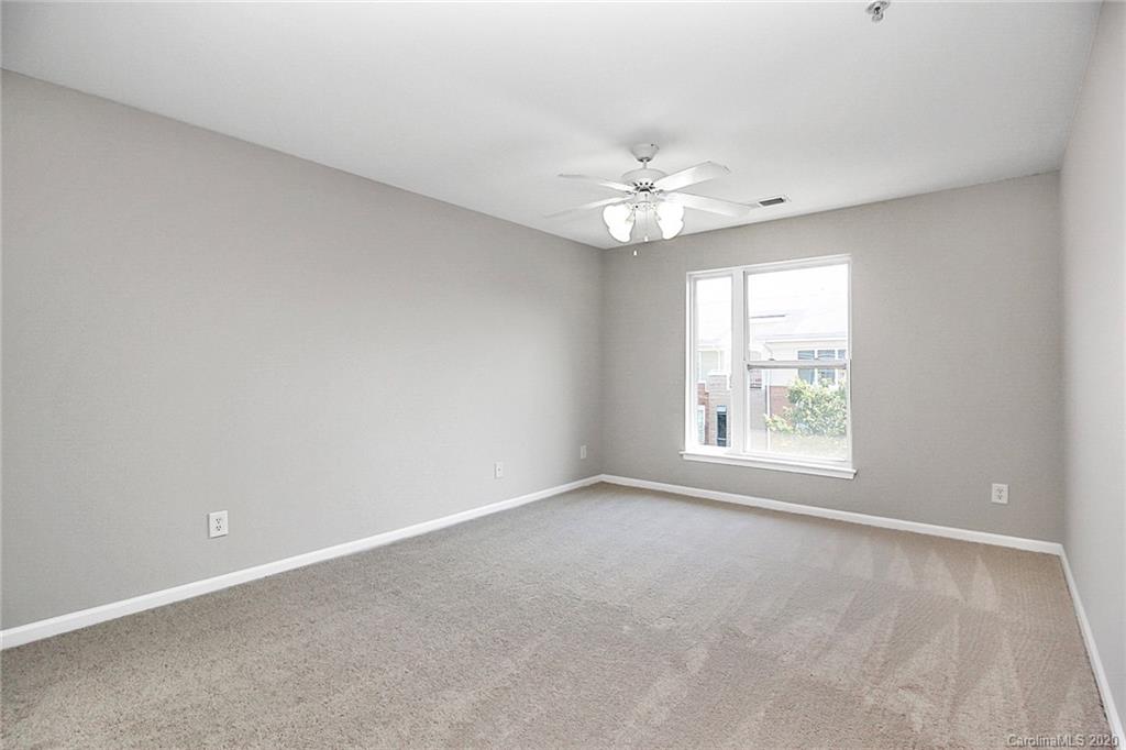 648 Raphael Place Charlotte, NC 28205 - Photo 38 of 48 an empty room with a window and a fan