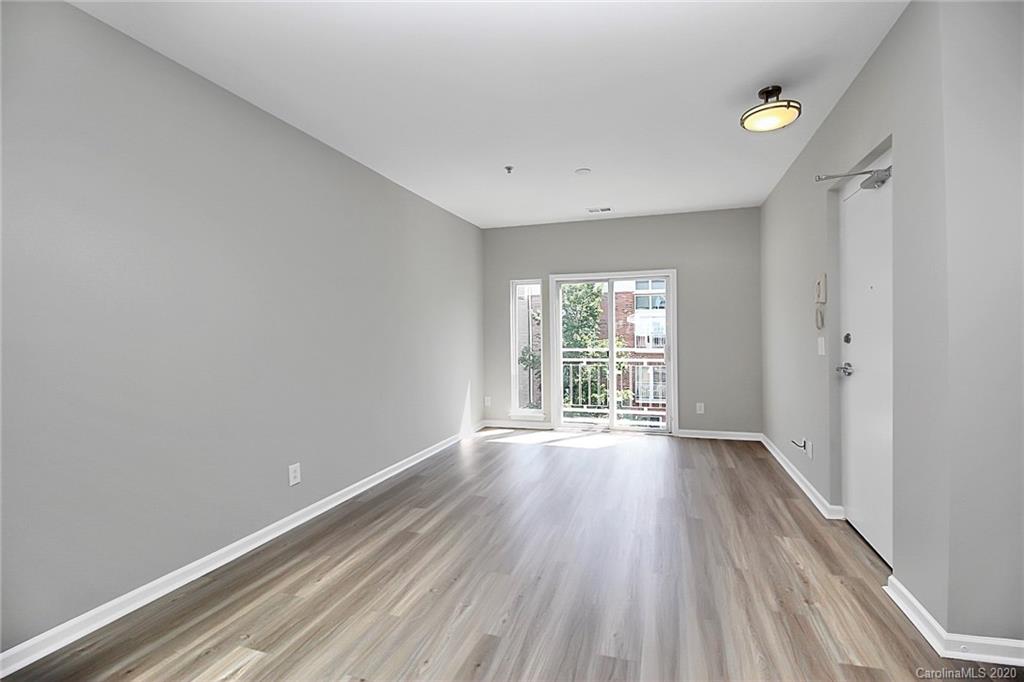 648 Raphael Place Charlotte, NC 28205 - Photo 6 of 48 a view of an empty room with wooden floor and a window