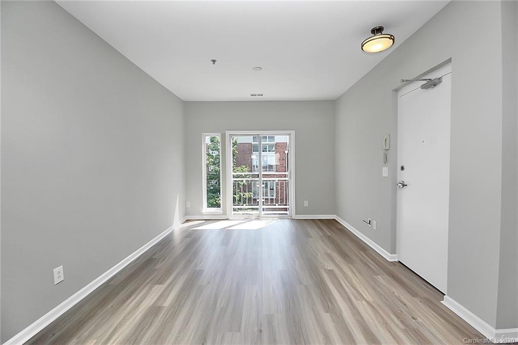 648 Raphael Place Charlotte, NC 28205 - Photo 7 of 48 a view of an empty room with wooden floor and a window
