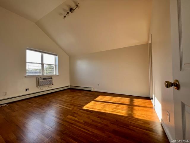 1307 Balcom Avenue Bronx, NY 10461 - Photo 12 of 26 wooden floor in an empty room with a window