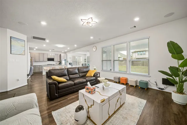 a living room with furniture and a potted plant