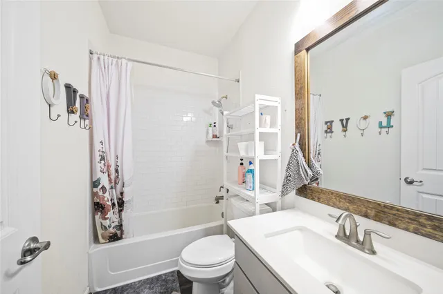 a bathroom with a sink toilet tub and shower