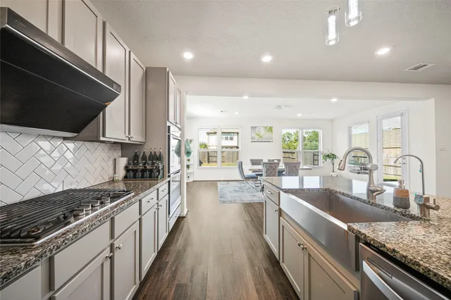a kitchen with counter top space a sink and appliances