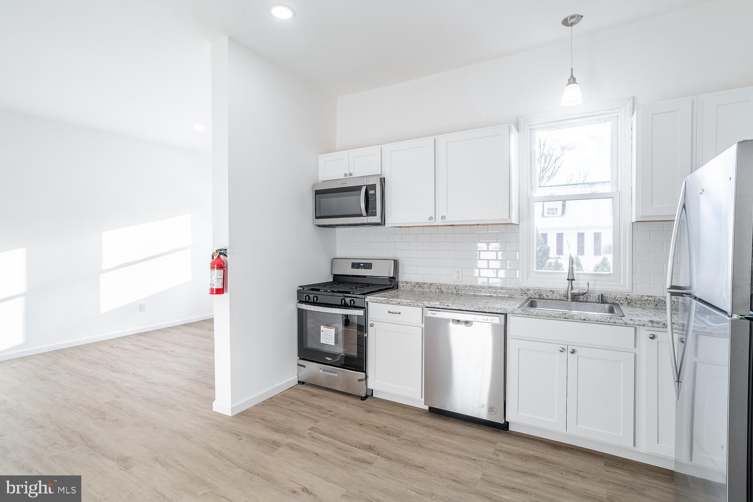 115 Hanover Street, Unit 4 Pemberton, NJ 08068 - Photo 1 of 14 a kitchen with granite countertop white cabinets and white appliances
