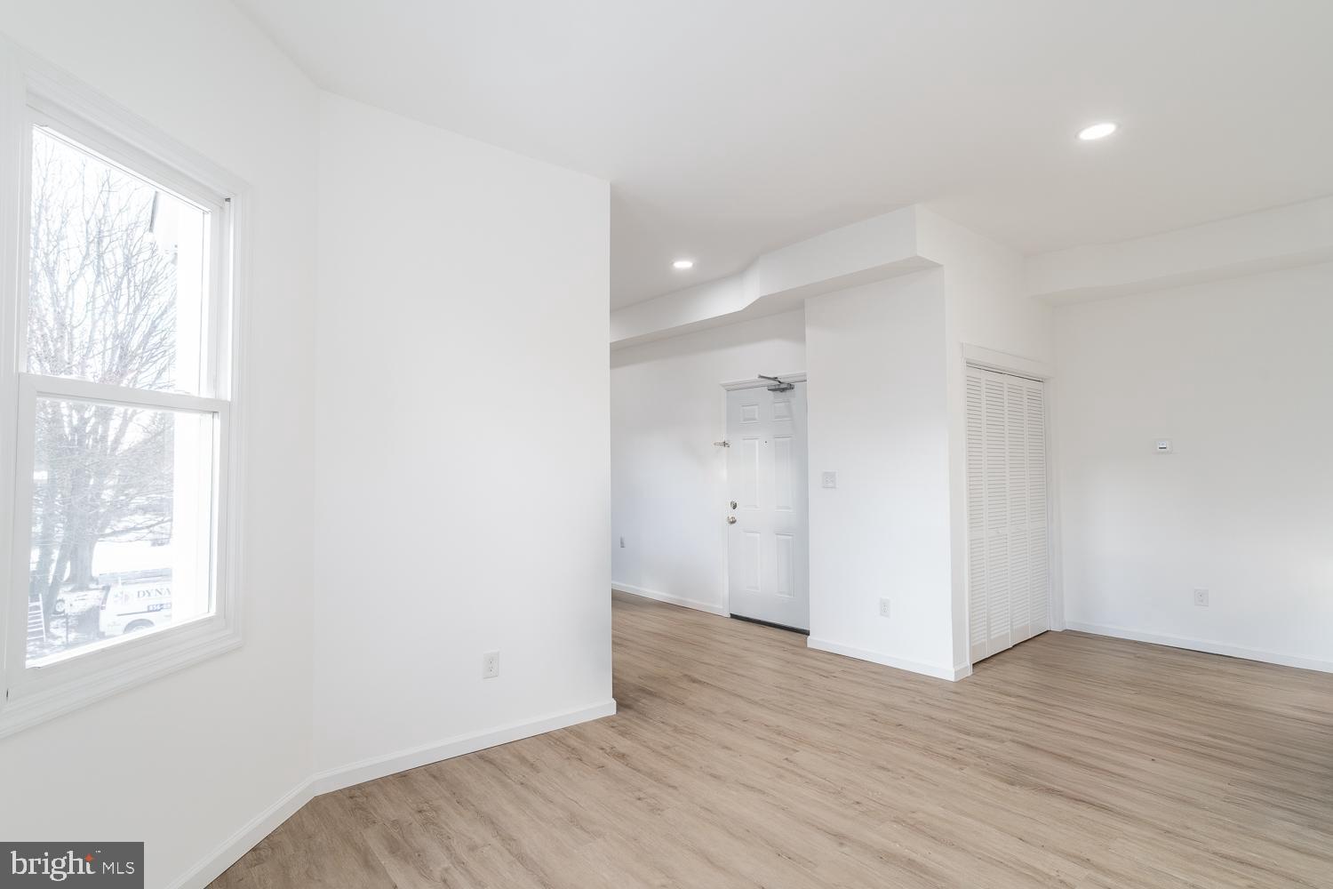 115 Hanover Street, Unit 4 Pemberton, NJ 08068 - Photo 2 of 14 an empty room with wooden floor and windows