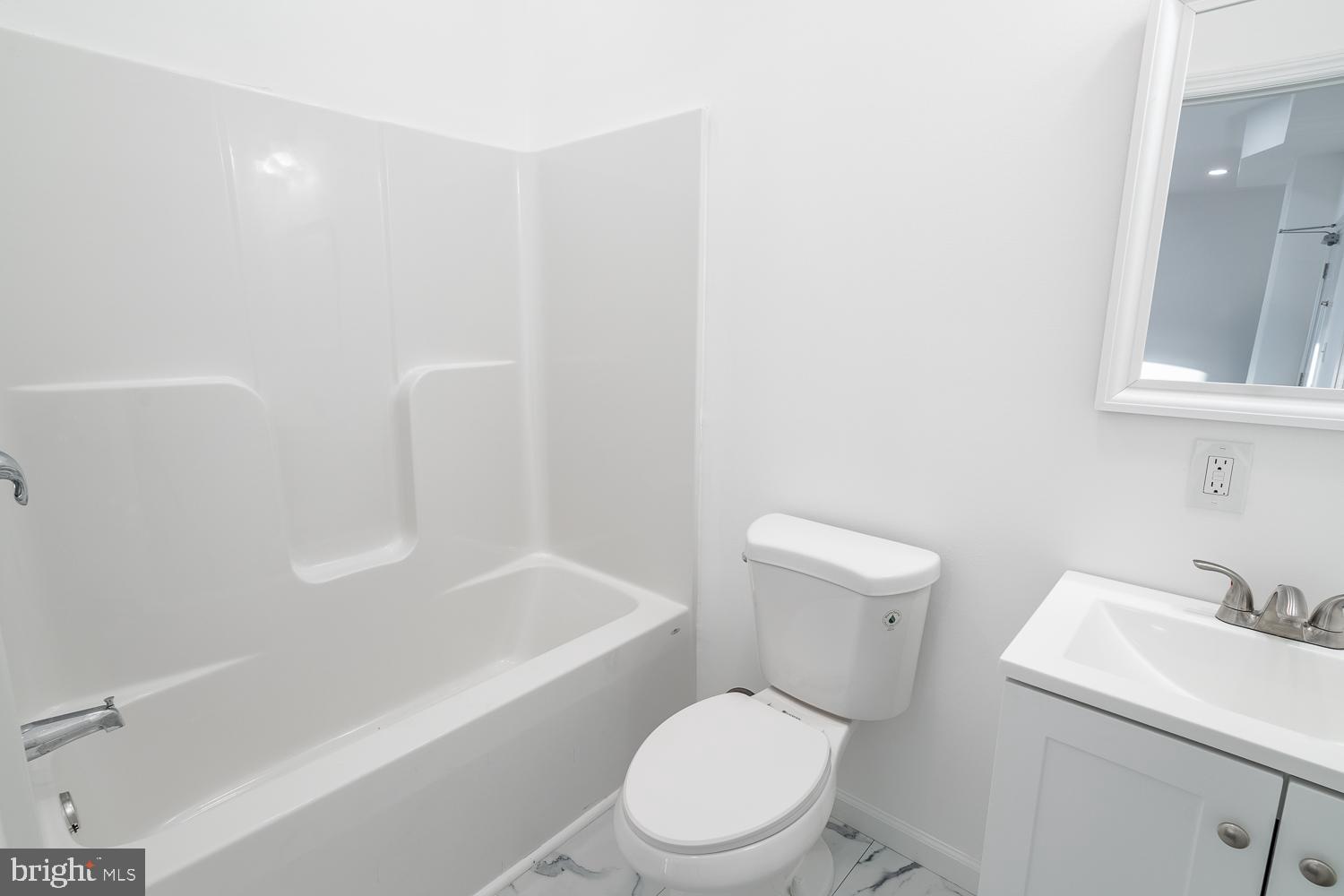 115 Hanover Street, Unit 4 Pemberton, NJ 08068 - Photo 5 of 14 a white toilet sitting next to a bath tub