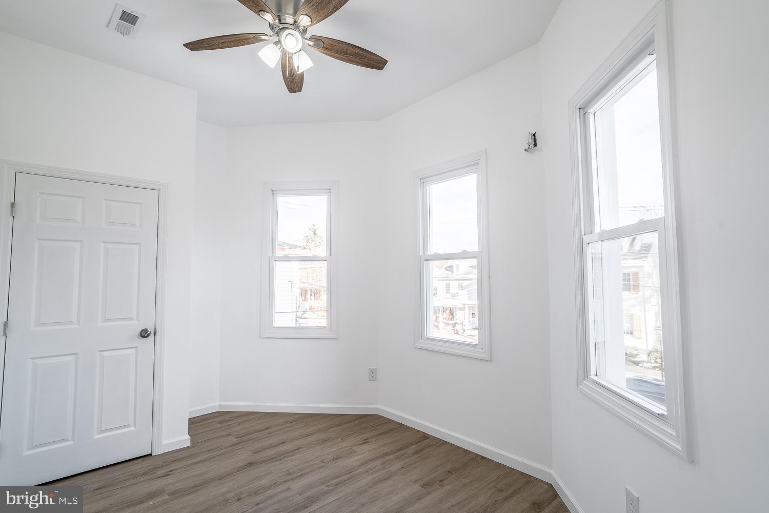 115 Hanover Street, Unit 4 Pemberton, NJ 08068 - Photo 6 of 14 a view of an empty room with wooden floor and a window