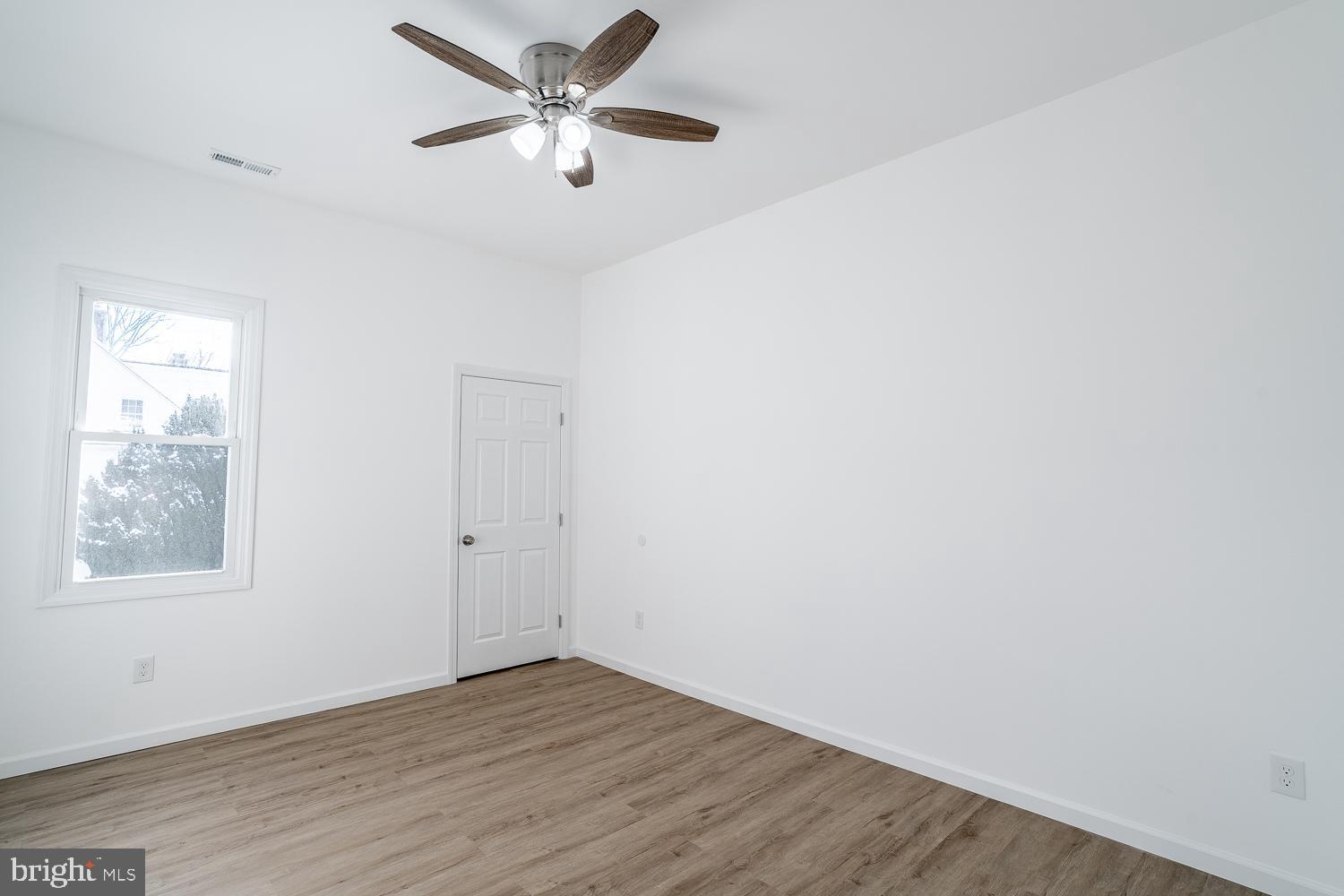 115 Hanover Street, Unit 4 Pemberton, NJ 08068 - Photo 10 of 14 an empty room with wooden floor ceiling fan and windows