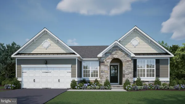 front view of a house with a yard and trees