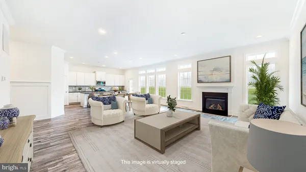 a living room with furniture a fireplace and a table