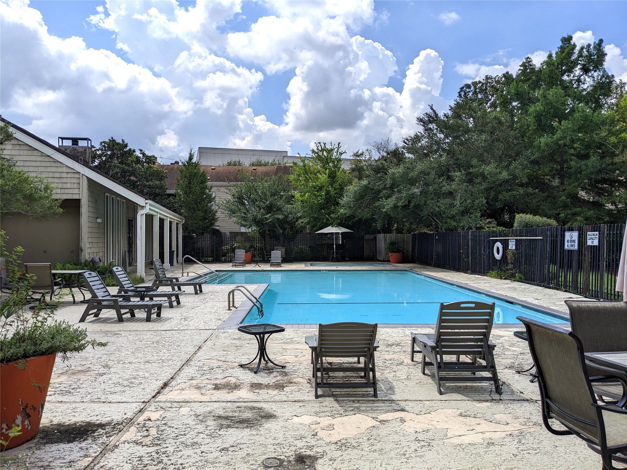 2100 Tanglewilde Street, Unit 421 Houston, TX 77063 - Photo 19 of 21 a view of a patio with a dining table and chairs with wooden floor