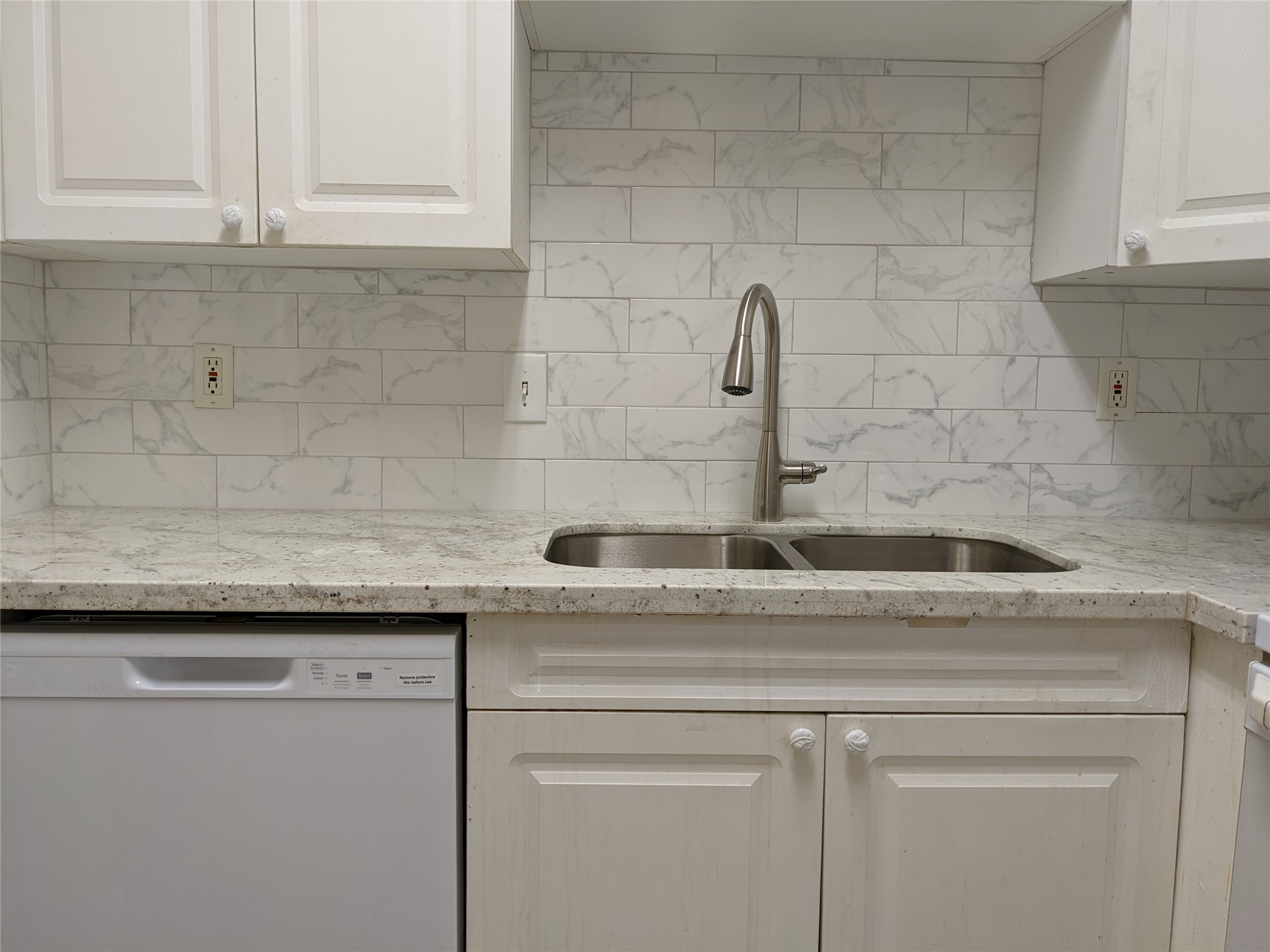 2100 Tanglewilde Street, Unit 421 Houston, TX 77063 - Photo 6 of 21 a sink with granite countertop white cabinets and a granite counter