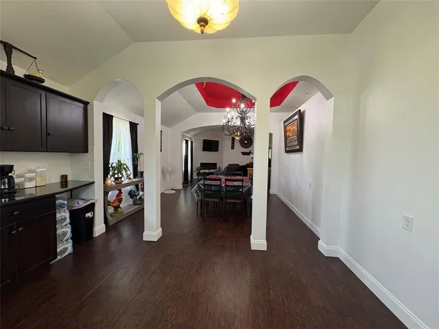 a view of a livingroom with furniture and an empty room