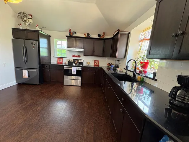 a kitchen with lots of counter top space and appliances