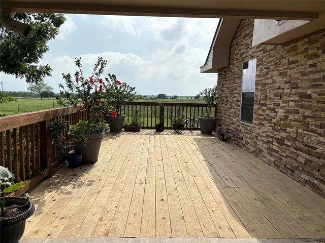 a view of balcony with wooden floor