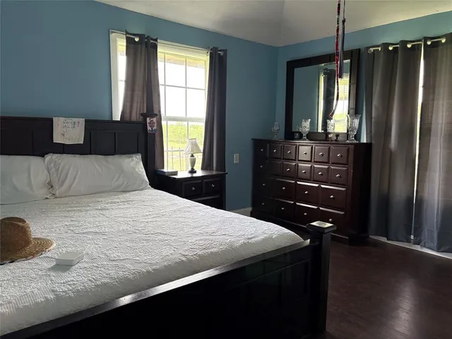 a bedroom with a bed and a dresser