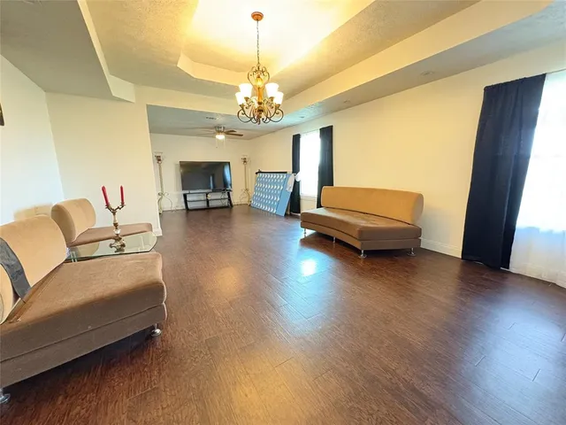 a living room with furniture and a chandelier