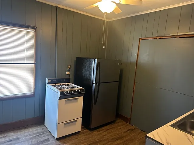 a kitchen with a refrigerator and a stove