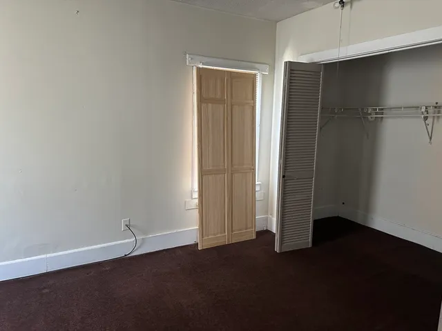 an empty room with closet area