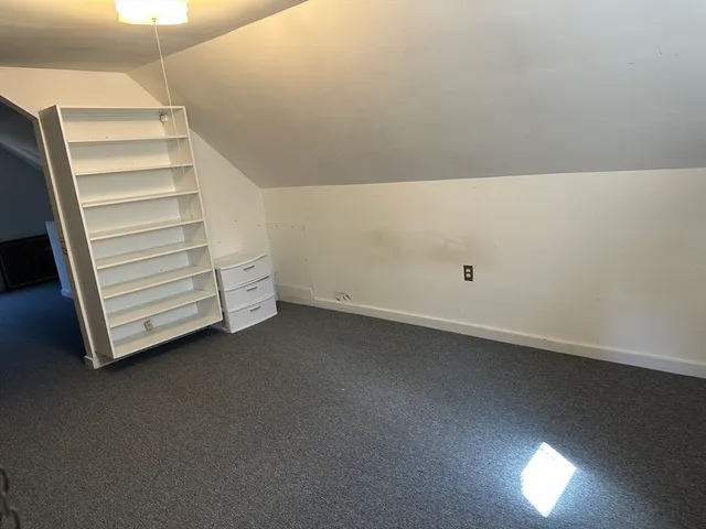 a view of an empty room with stairs and ventilation