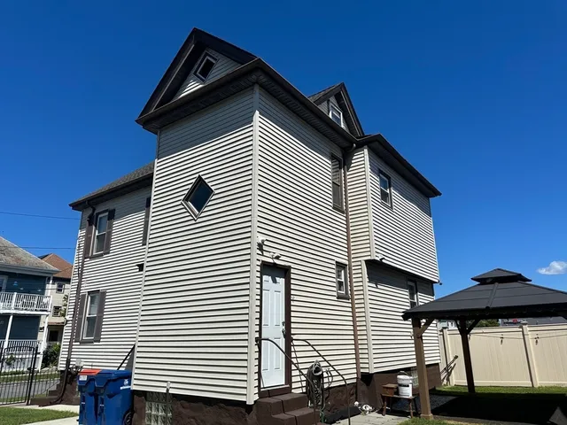 a view of house with a space and a trees