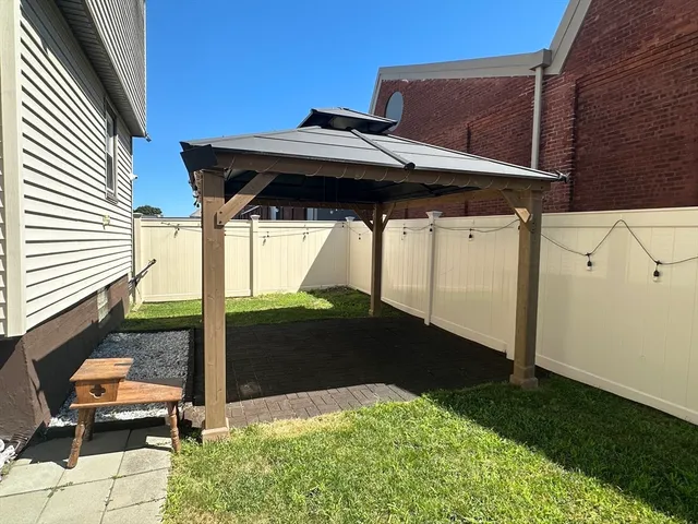 a backyard of a house with table and chairs