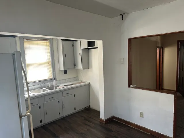 a bathroom with a double vanity sink and mirror with shower