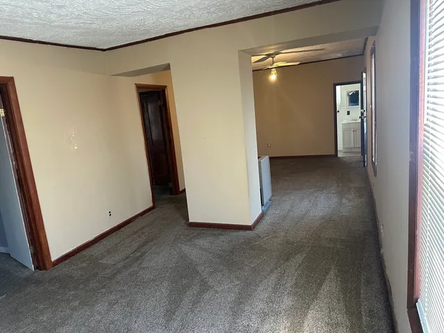 an empty room with closet and wooden floor