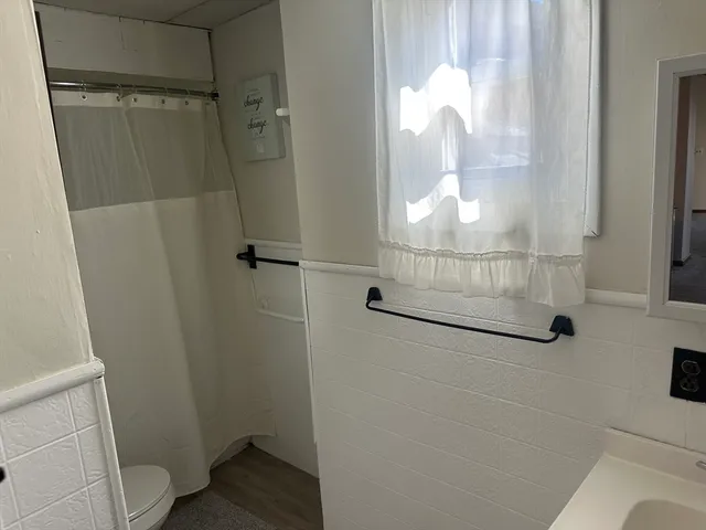 a bathroom with a glass shower door