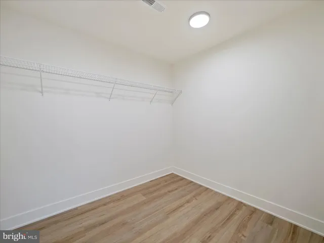 a bathroom with a double vanity sink toilet and a mirror