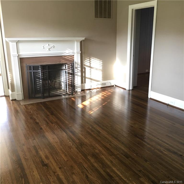 3719 Park Road Charlotte, NC 28209 - Photo 5 of 14 a view of an empty room with wooden floor fireplace and a window