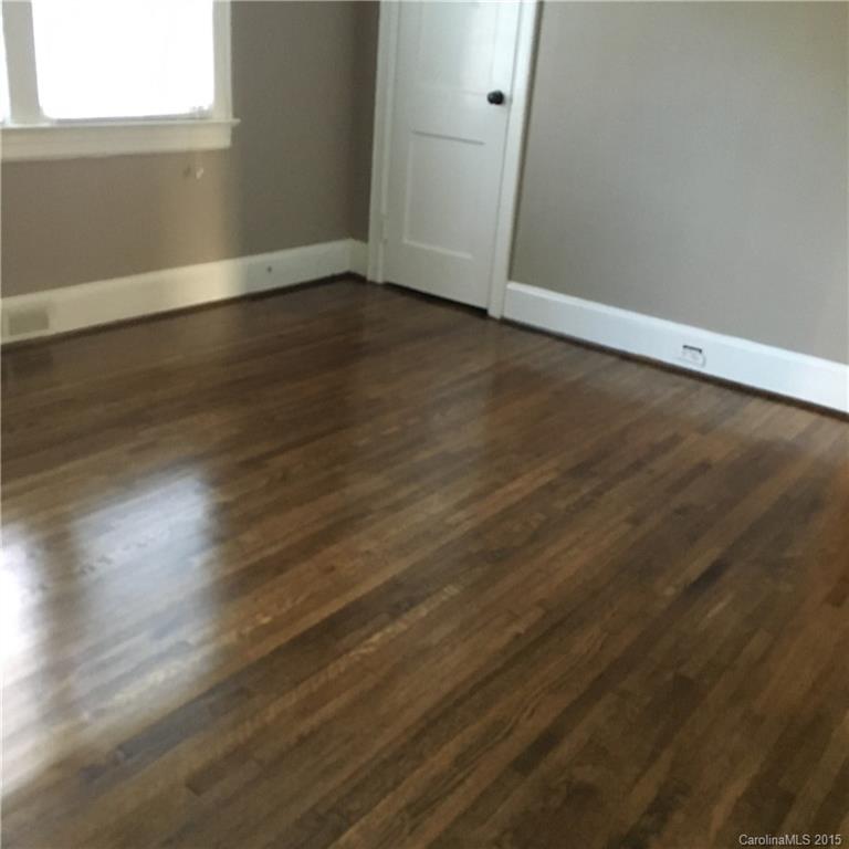 3719 Park Road Charlotte, NC 28209 - Photo 8 of 14 an empty room with wooden floor and windows