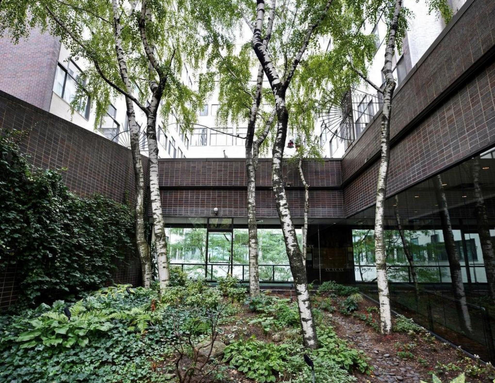 77 Bleecker Street, Unit 804 Manhattan, NY 10012 - Photo 10 of 12 a backyard of a house with seating space and garden