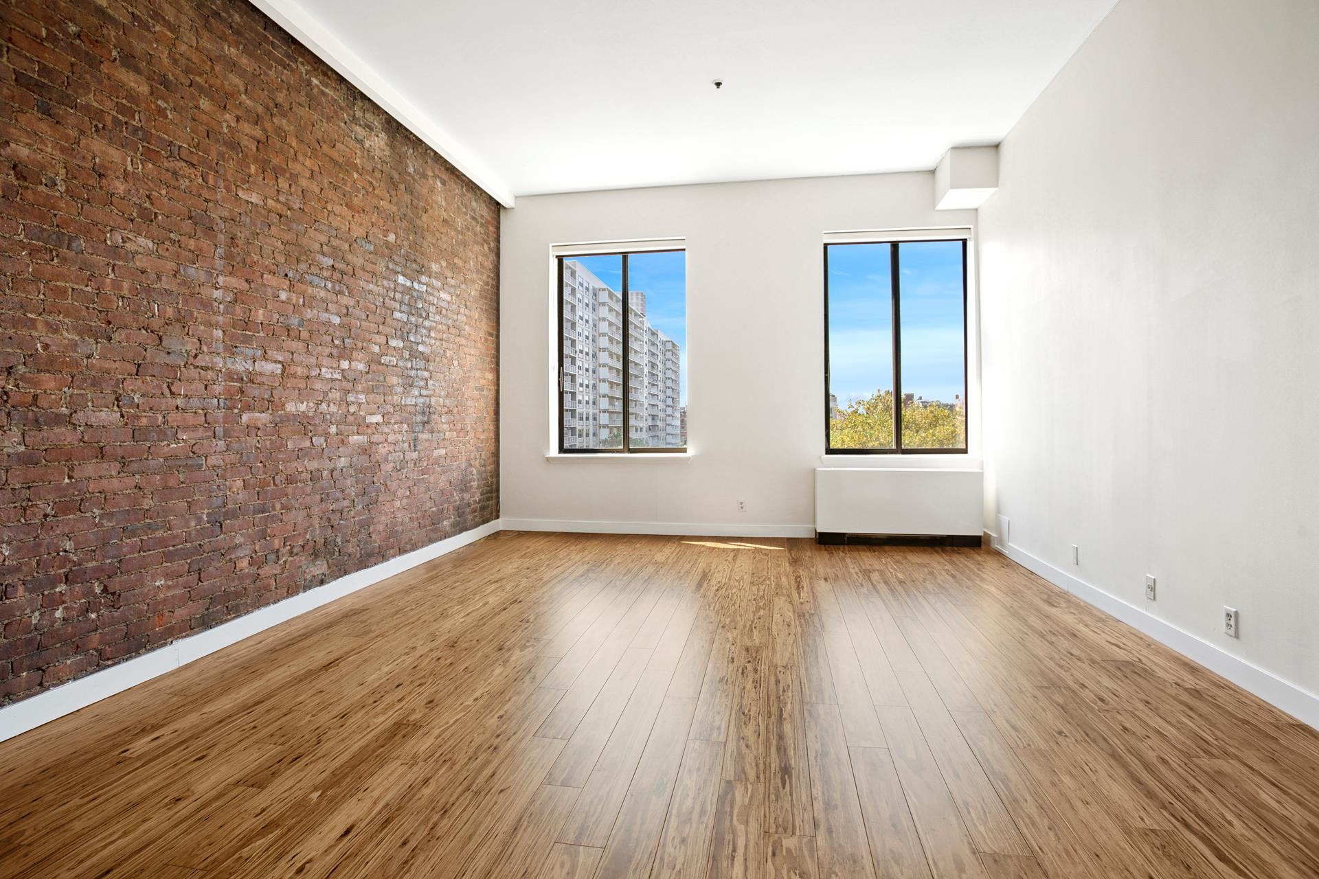 77 Bleecker Street, Unit 804 Manhattan, NY 10012 - Photo 2 of 12 wooden floor in an empty room with a window