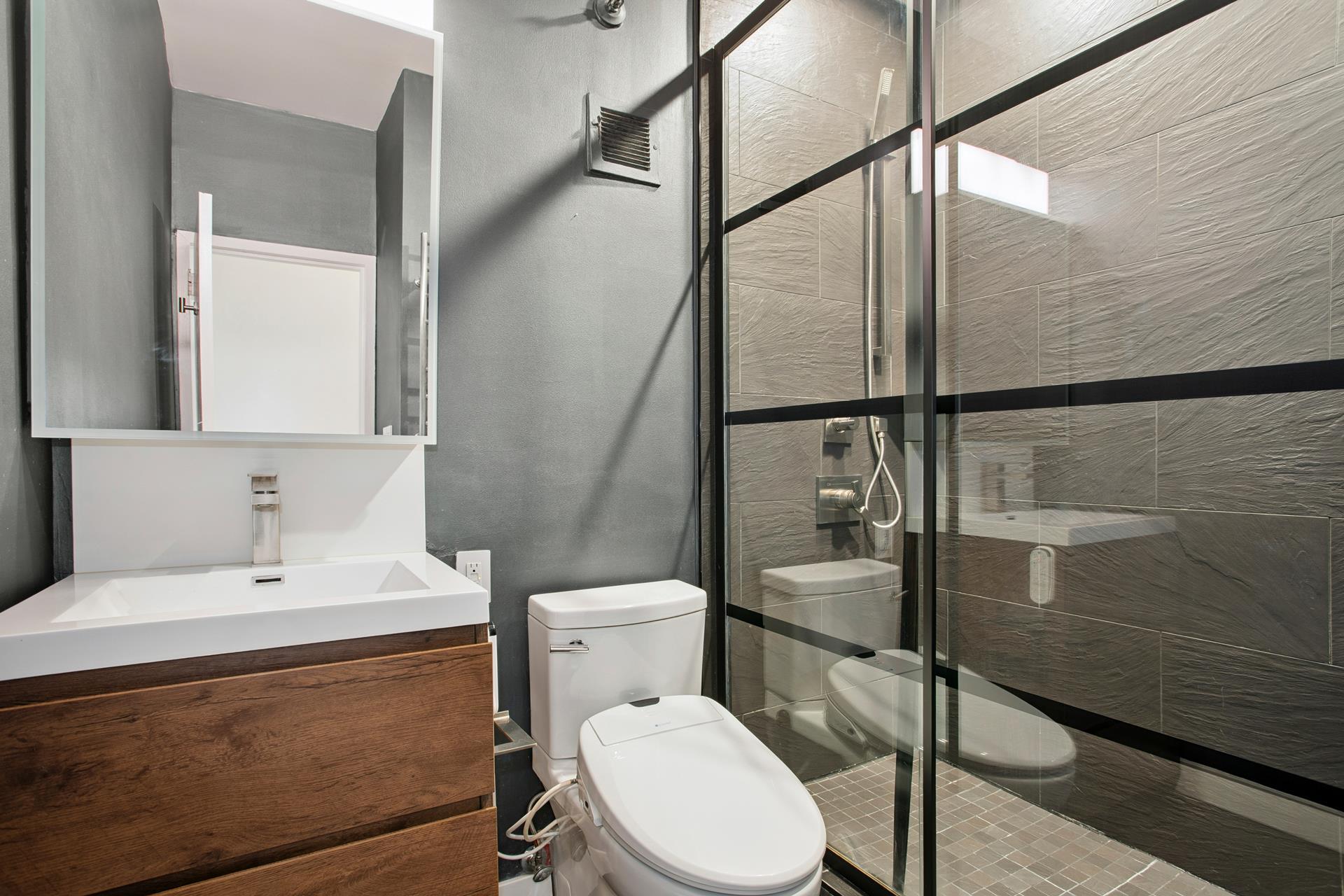 77 Bleecker Street, Unit 804 Manhattan, NY 10012 - Photo 7 of 12 a white toilet sitting next to a bathroom sink