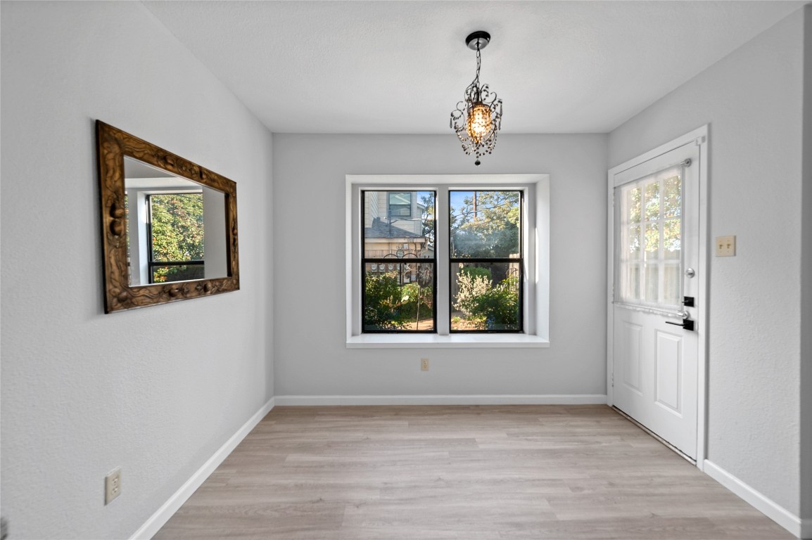 11301 Jollyville Road, Unit B3 Austin, TX 78759 - Photo 5 of 21 a view of an empty room with wooden floor and windows
