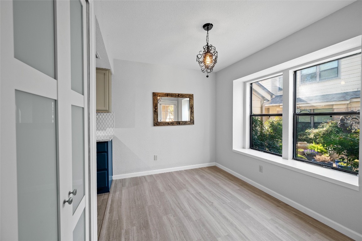 11301 Jollyville Road, Unit B3 Austin, TX 78759 - Photo 6 of 21 wooden floor in an empty room with a window