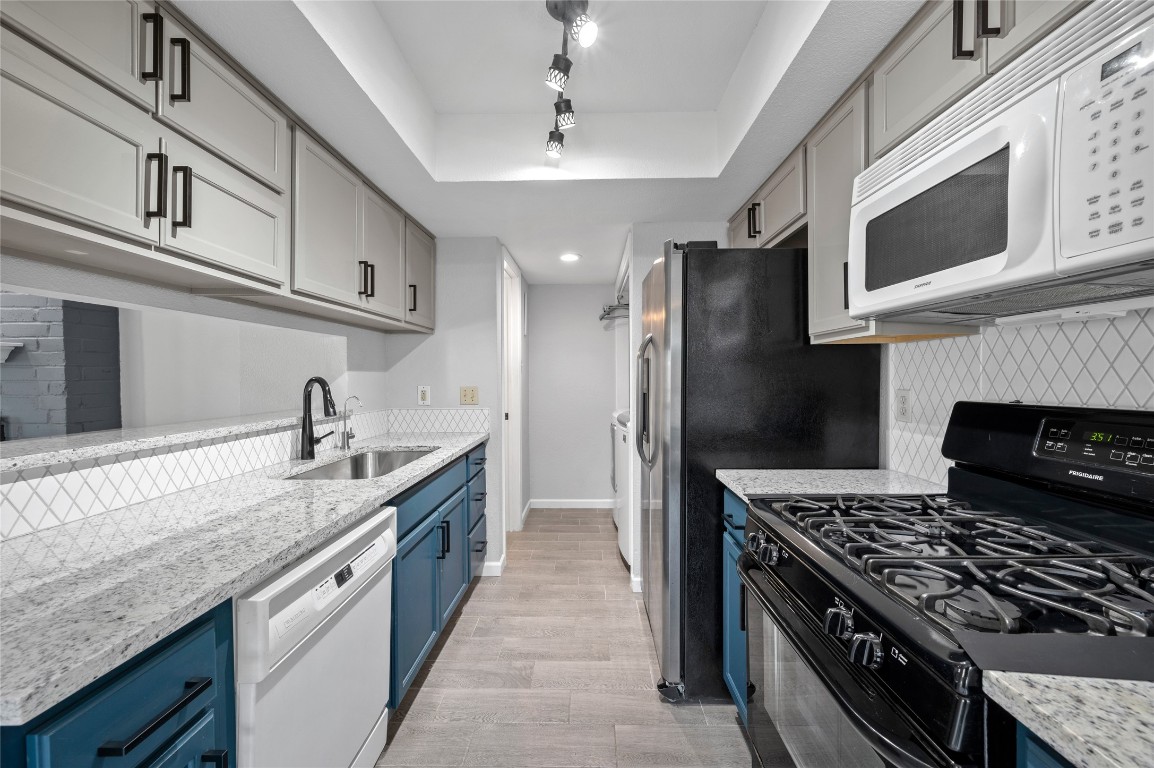 11301 Jollyville Road, Unit B3 Austin, TX 78759 - Photo 8 of 21 a kitchen with stainless steel appliances granite countertop a stove and a sink