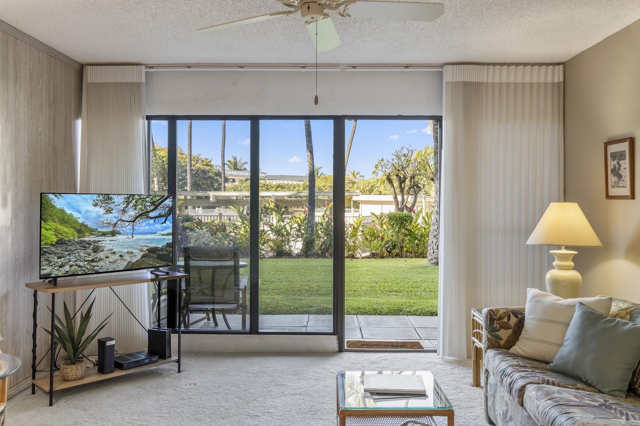 2531 South Kihei Road, Unit DG10 Kihei, HI 96753 - Photo 11 of 31 a living room with a large window and a table