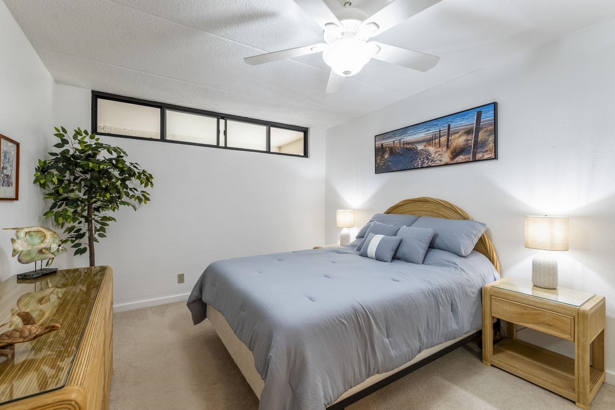 2531 South Kihei Road, Unit DG10 Kihei, HI 96753 - Photo 12 of 31 a bedroom with a bed and a chandelier