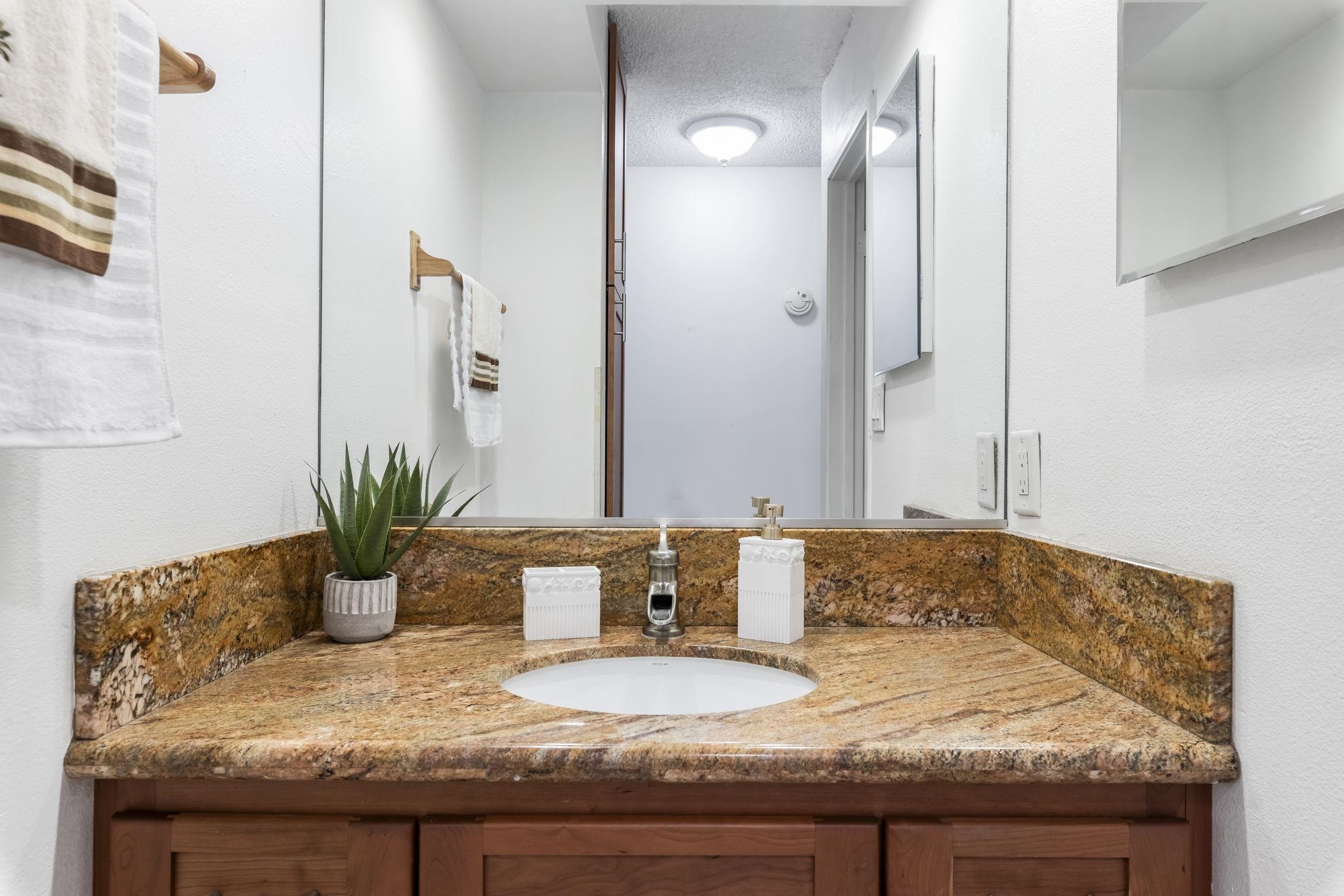 2531 South Kihei Road, Unit DG10 Kihei, HI 96753 - Photo 15 of 31 a bathroom with a granite countertop sink a mirror and a shower