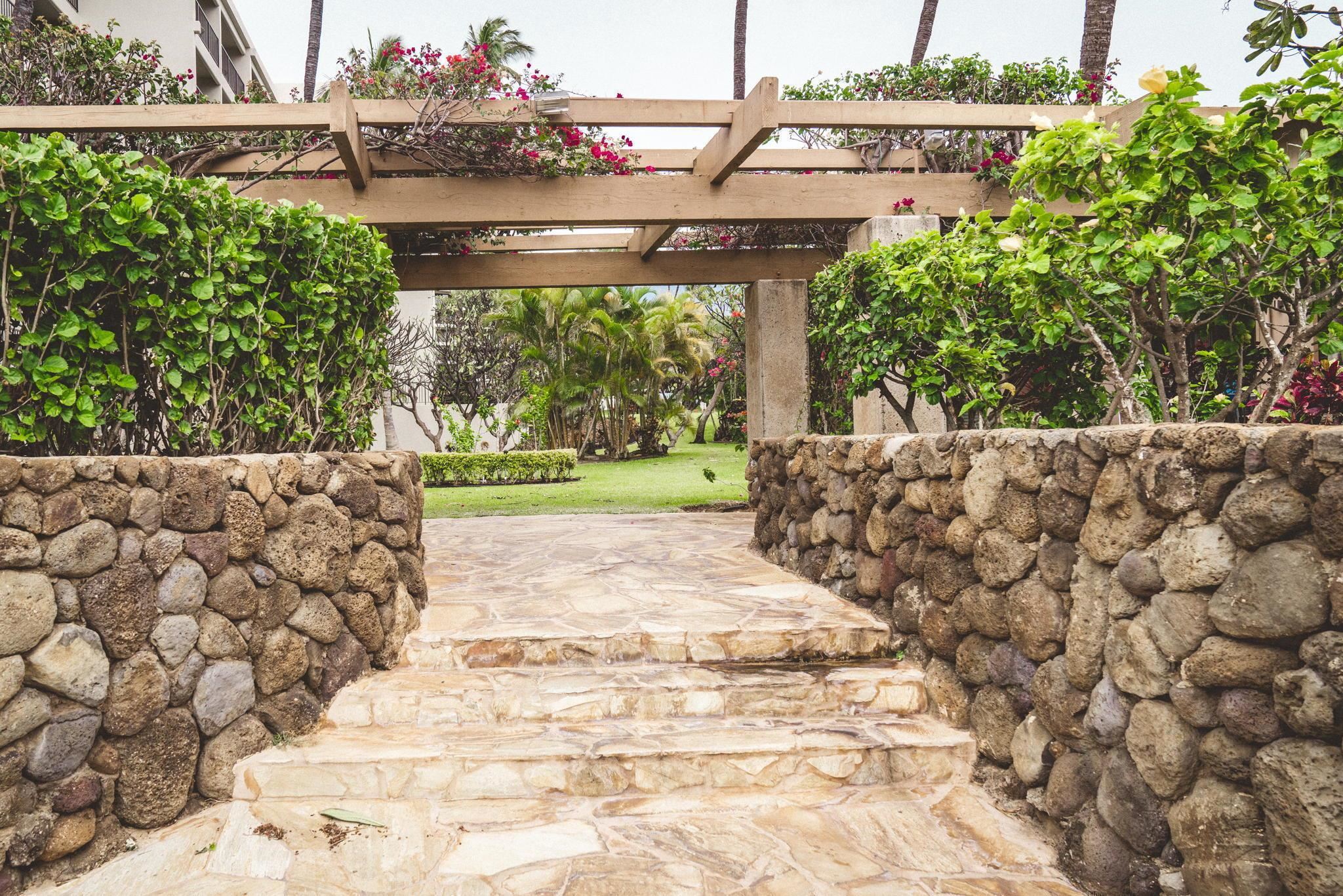 2531 South Kihei Road, Unit DG10 Kihei, HI 96753 - Photo 21 of 31 a view of a pathway both side of white house with a large tree