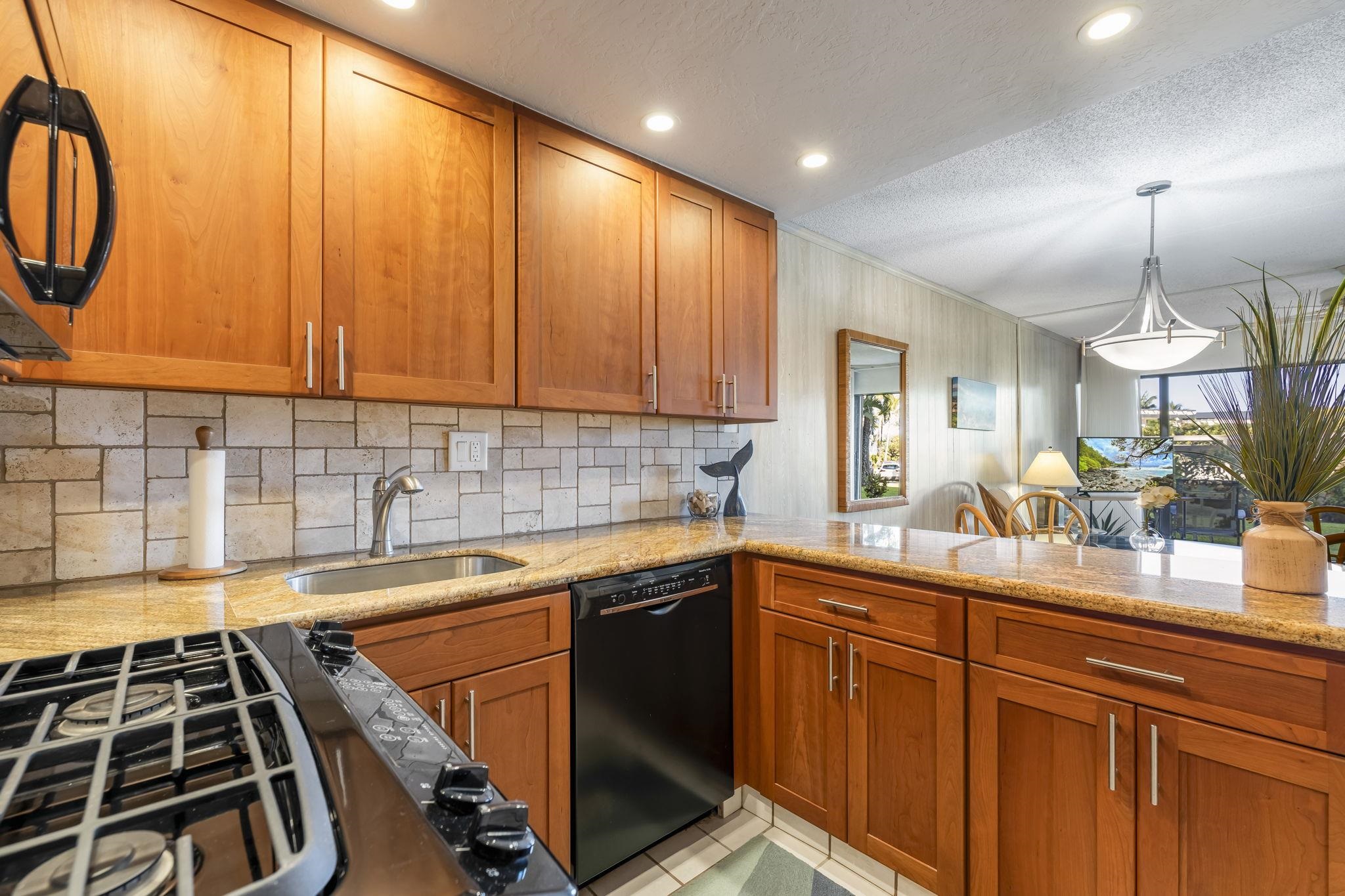 2531 South Kihei Road, Unit DG10 Kihei, HI 96753 - Photo 4 of 31 a kitchen with wooden cabinets and a sink