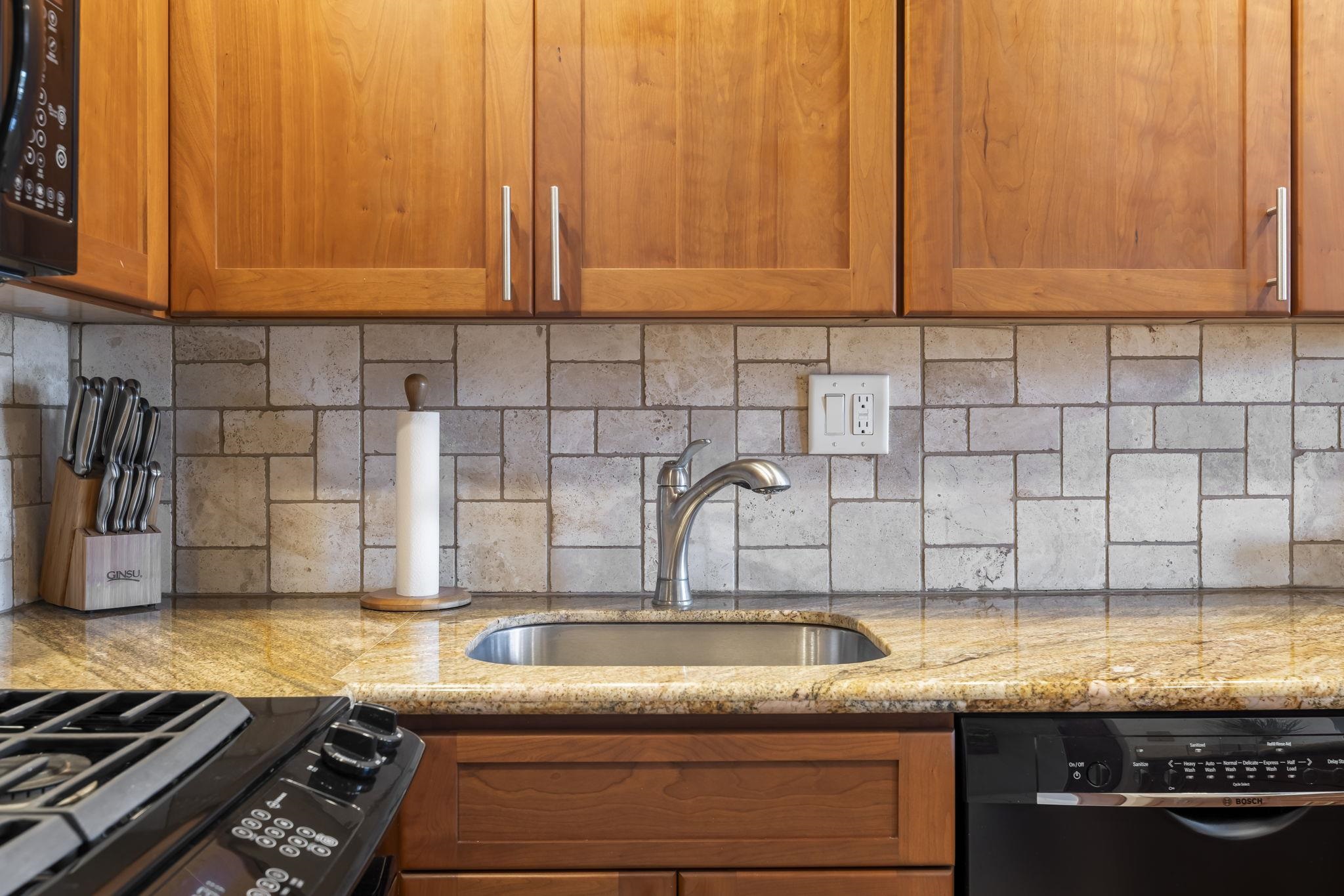 2531 South Kihei Road, Unit DG10 Kihei, HI 96753 - Photo 5 of 31 a kitchen with granite countertop a sink and cabinets