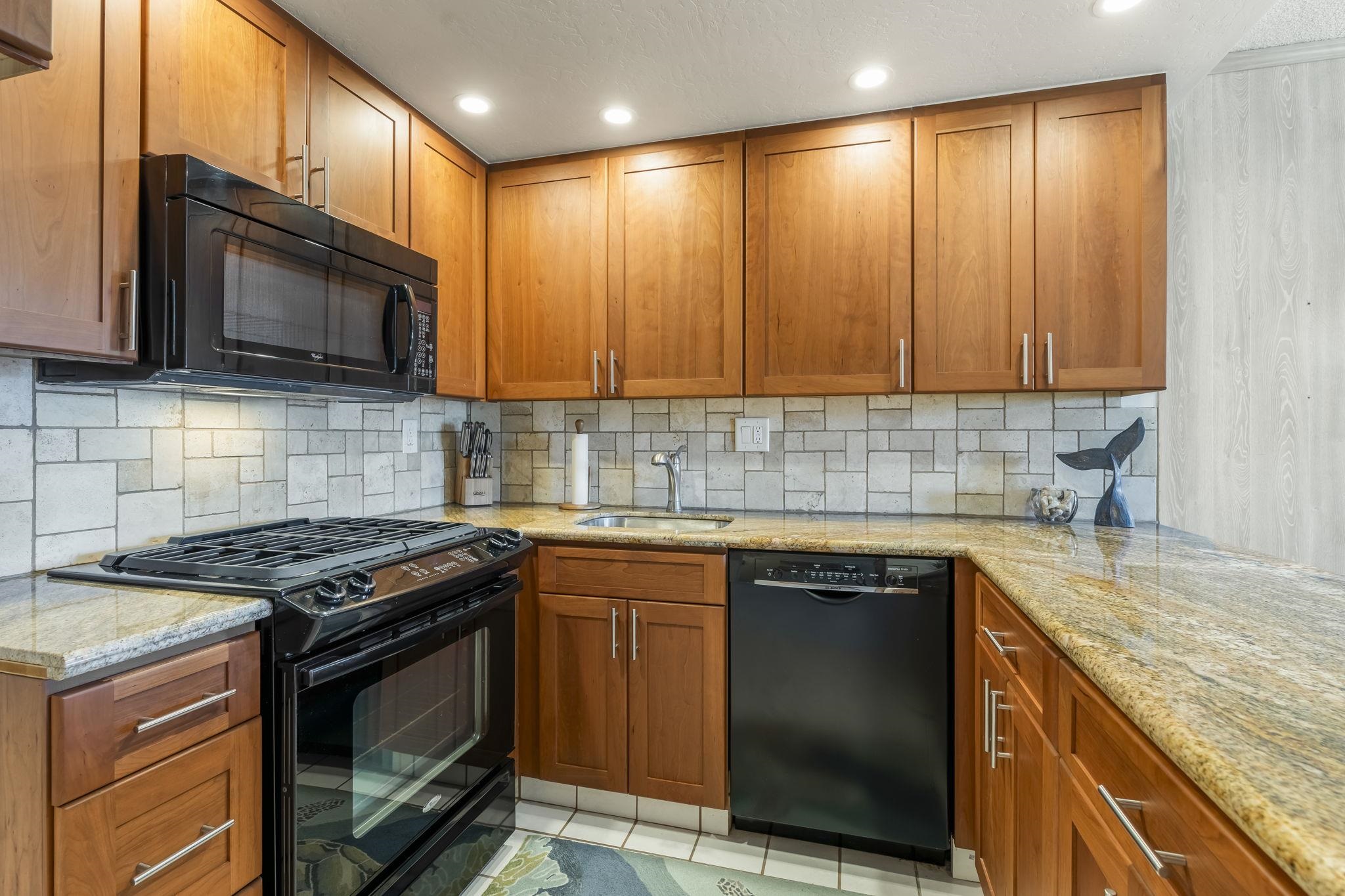 2531 South Kihei Road, Unit DG10 Kihei, HI 96753 - Photo 6 of 31 a kitchen with granite countertop cabinets stainless steel appliances and sink