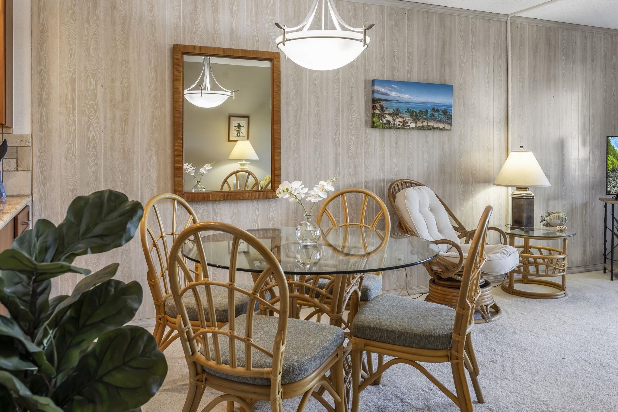 2531 South Kihei Road, Unit DG10 Kihei, HI 96753 - Photo 10 of 31 a view of a dining room with furniture a chandelier and wooden floor
