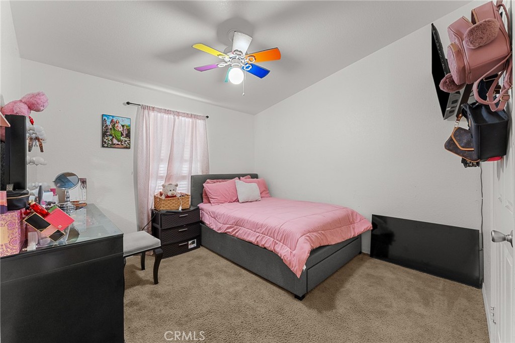 138 Sir Damas Drive Riverside, CA 92507 - Photo 13 of 36 a bedroom with a bed and a chandelier