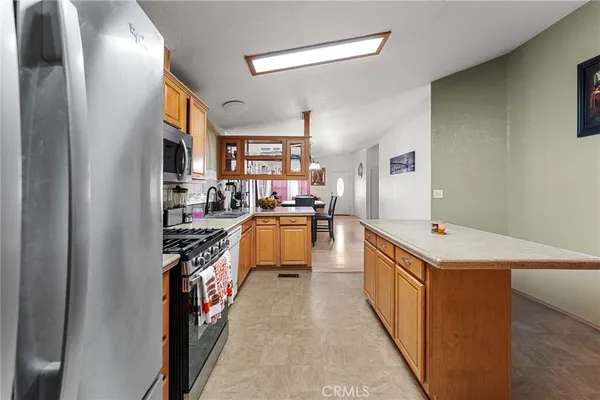 a kitchen with counter top space and stainless steel appliances