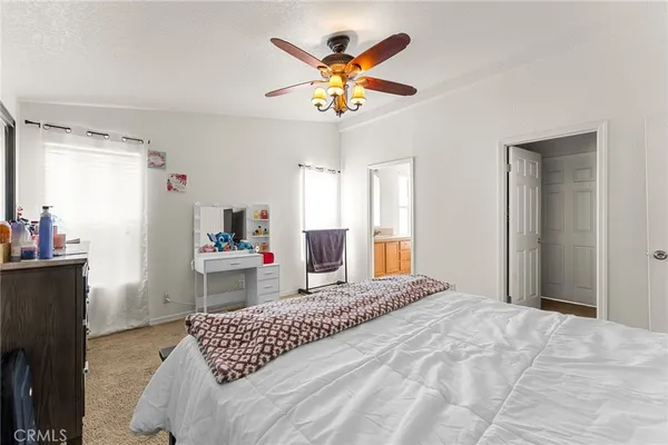 a bedroom that has a bed and a chandelier
