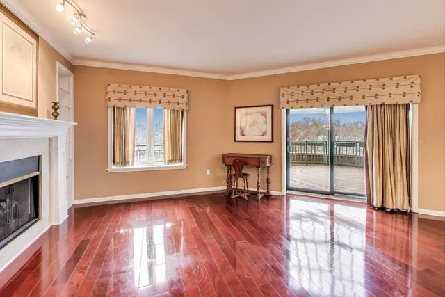 a view of a livingroom with furniture a fireplace and wooden floor